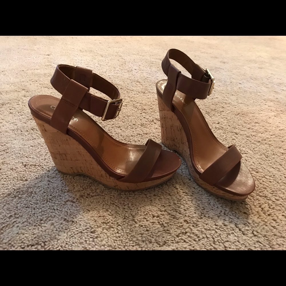 Calvin Klein wedges with gold buckle.